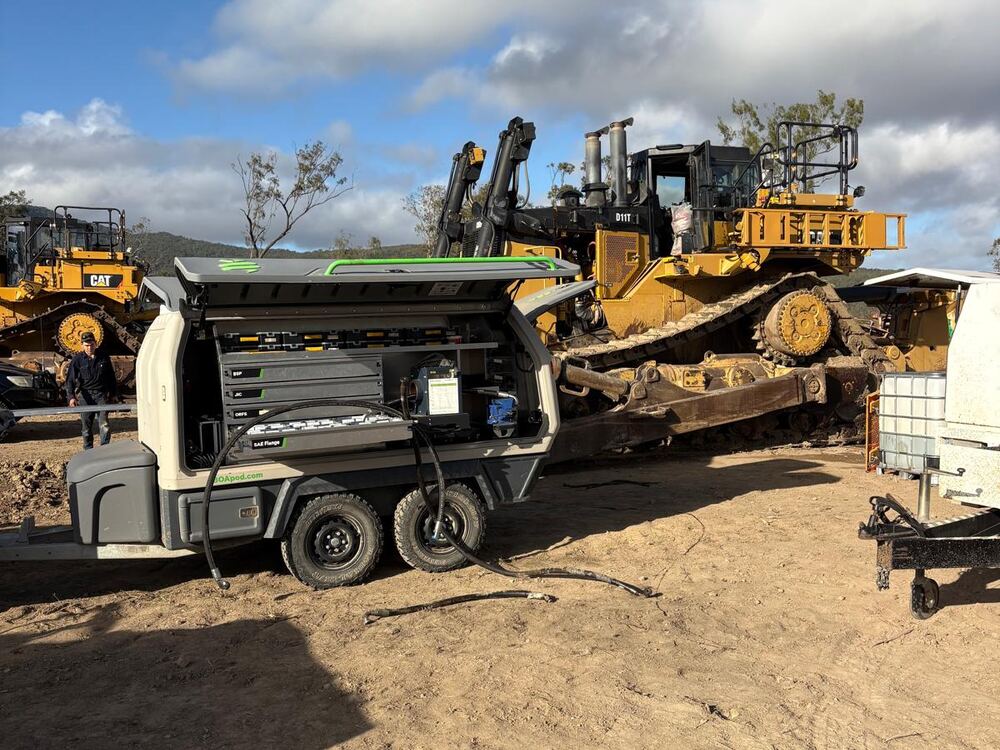 Mobile hydraulic hose support trailer alongside a CAT D11T dozer, North QLD